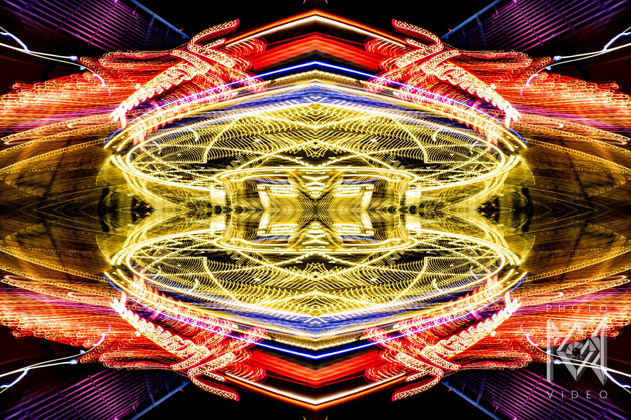 Red and yellow light trails mirrored into a symmetrical pattern