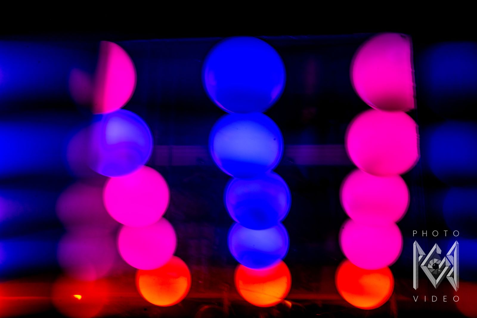 Pink, blue and red lights blurred into soft stacked globes