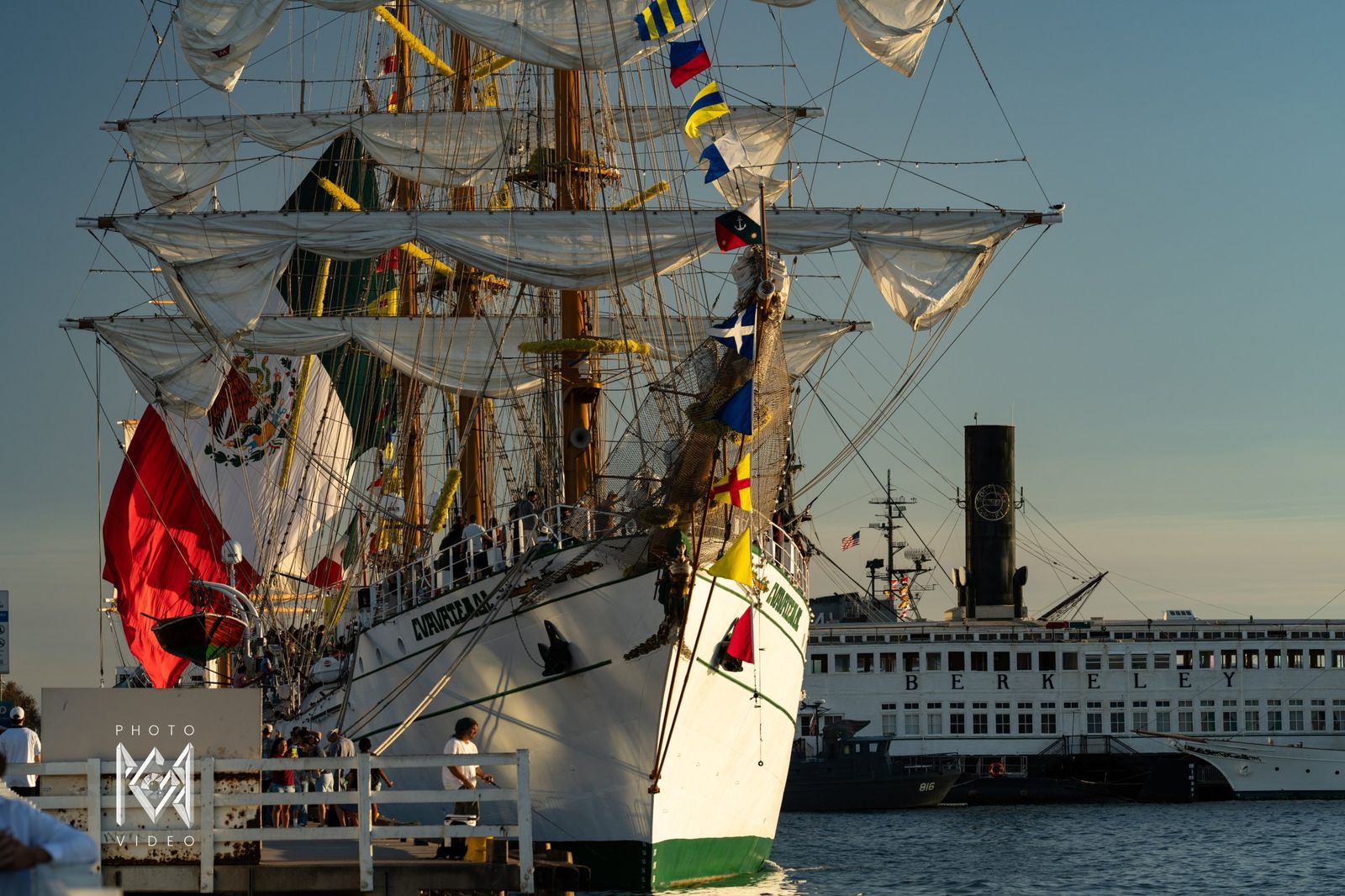 The bow with signal flags flying, a historic ferry beside her