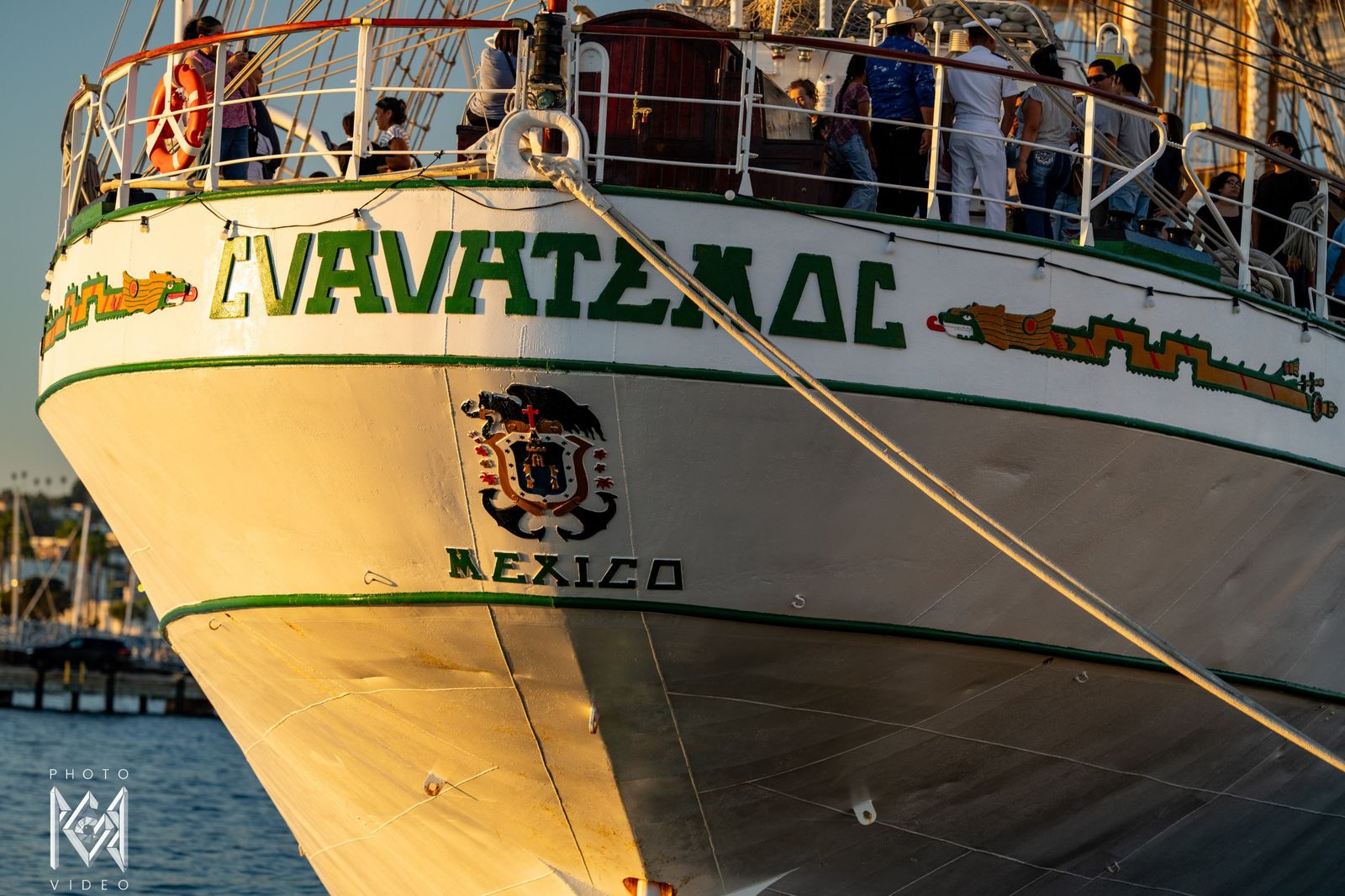 The stern with the ship's name, the Mexican crest and 'Mexico', crew and visitors at the rail