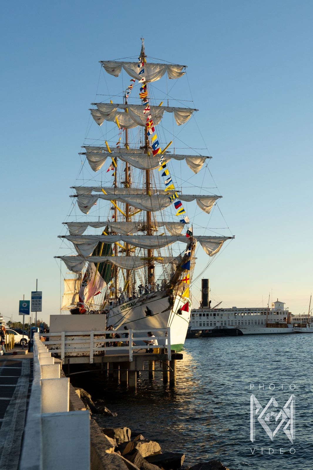 The bow beside a pier with a historic ferry across the water