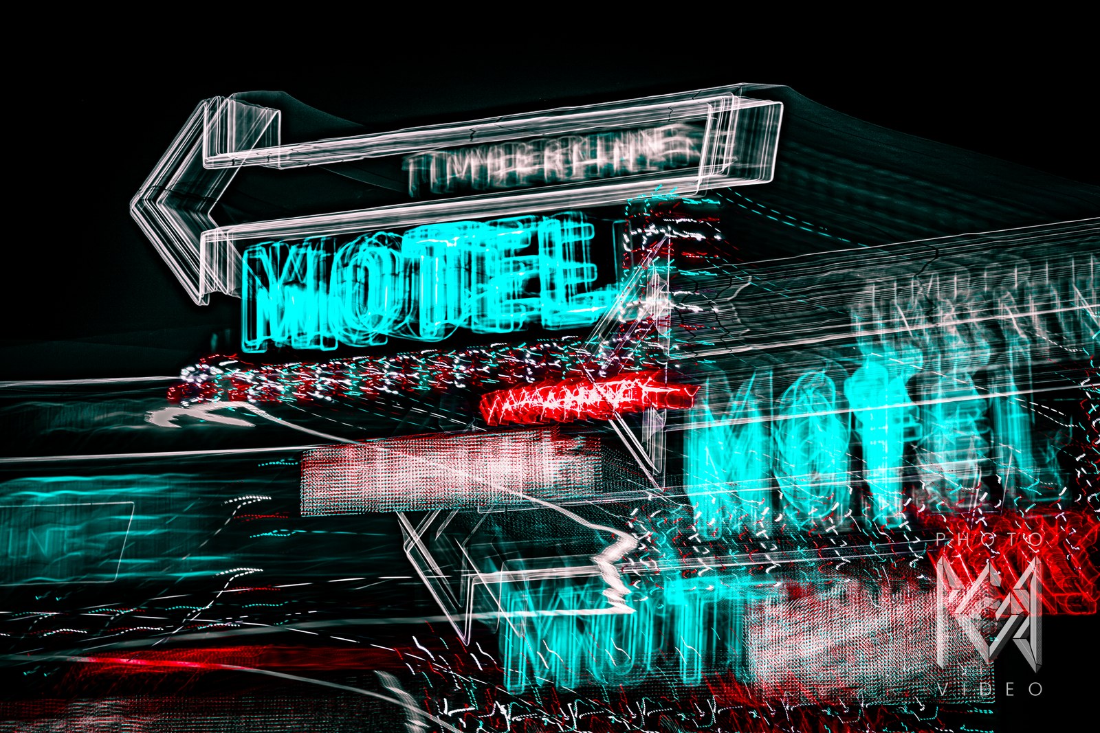 A neon motel sign streaked into trails of teal, white and red light, the arrow and letters smeared by long exposure on black